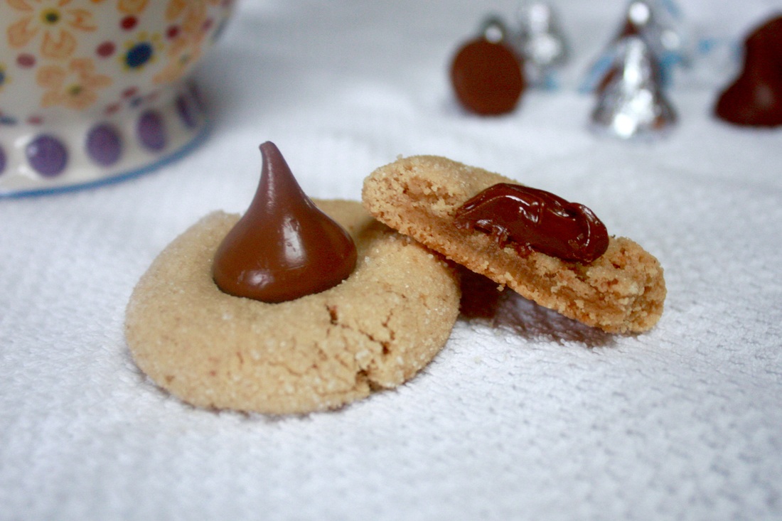 Peanut Butter Blossoms - Soft peanut butter cookies rolled in granulated sugar with a Hershey’s kiss on top. - Kate's Sweets