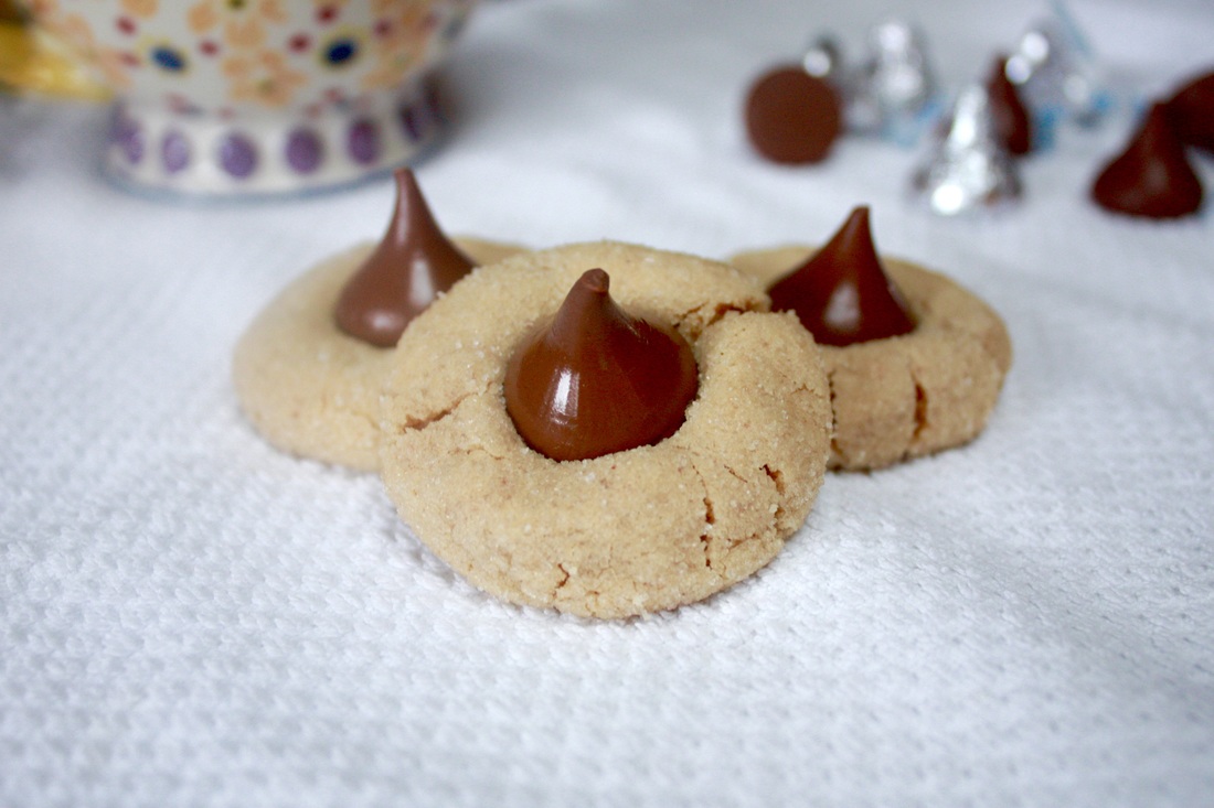 Peanut Butter Blossoms - Soft peanut butter cookies rolled in granulated sugar with a Hershey’s kiss on top. - Kate's Sweets